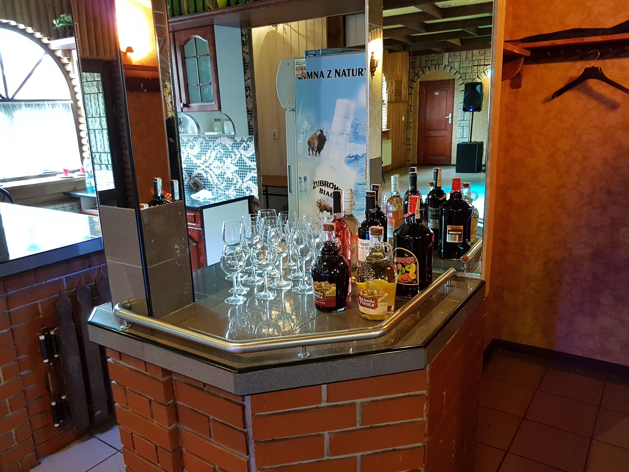 Ceglany bar z kieliszkami i butelkami, przygotowany przed przyjęciem